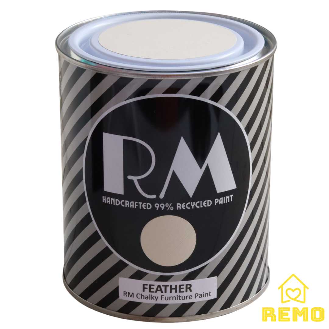 Front angle view of a black white and grey striped tin with round circle paint swatches in the colour PIPER which is a light cream with a yellow hue.