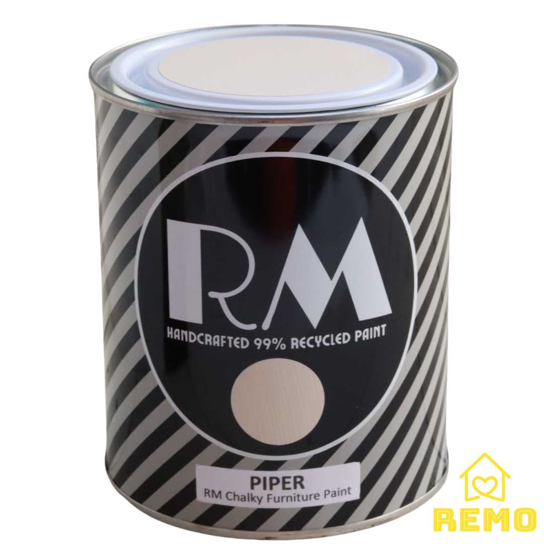 Front angle view of a black white and grey striped tin with round circle paint swatches in the colour PIPER which is a light cream with a brown hue.