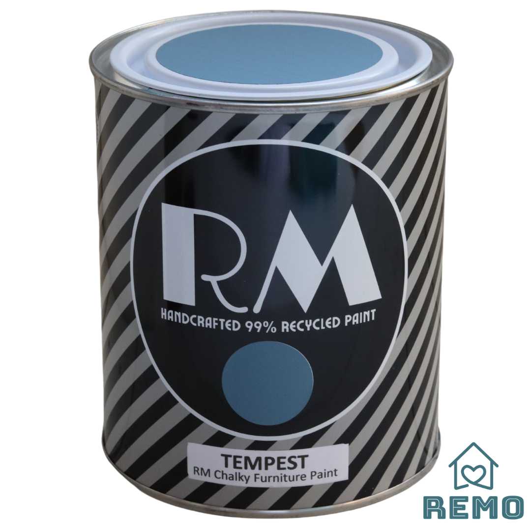 An image of a Striped RM Chalky Furniture Paint Tin with painted swatches on the front and on the top of tin in the colour TEMPEST is a blue with a grey hue.