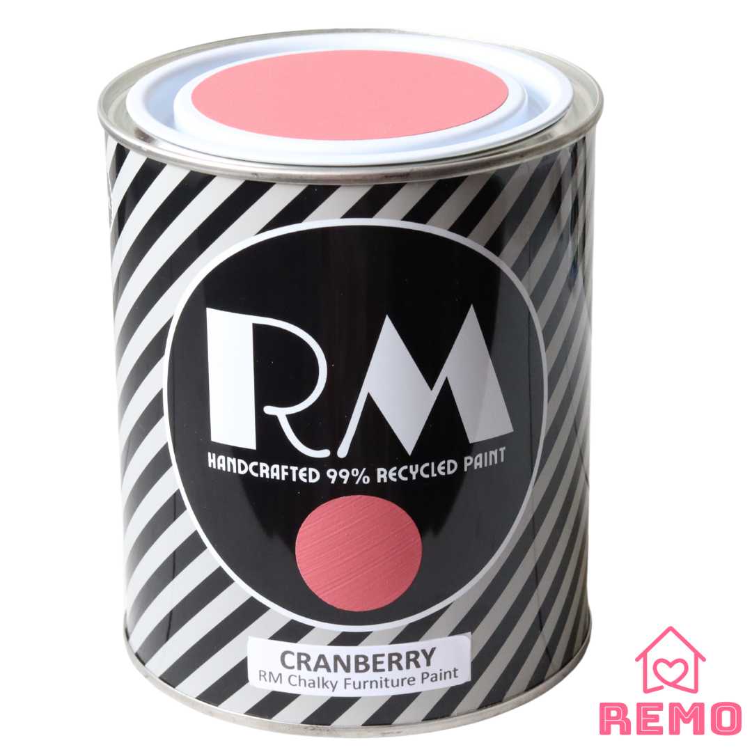 Front angle view of a black white and grey striped tin with round circle paint swatches in the colour CRANBEERY which is a red with a pink hue.
